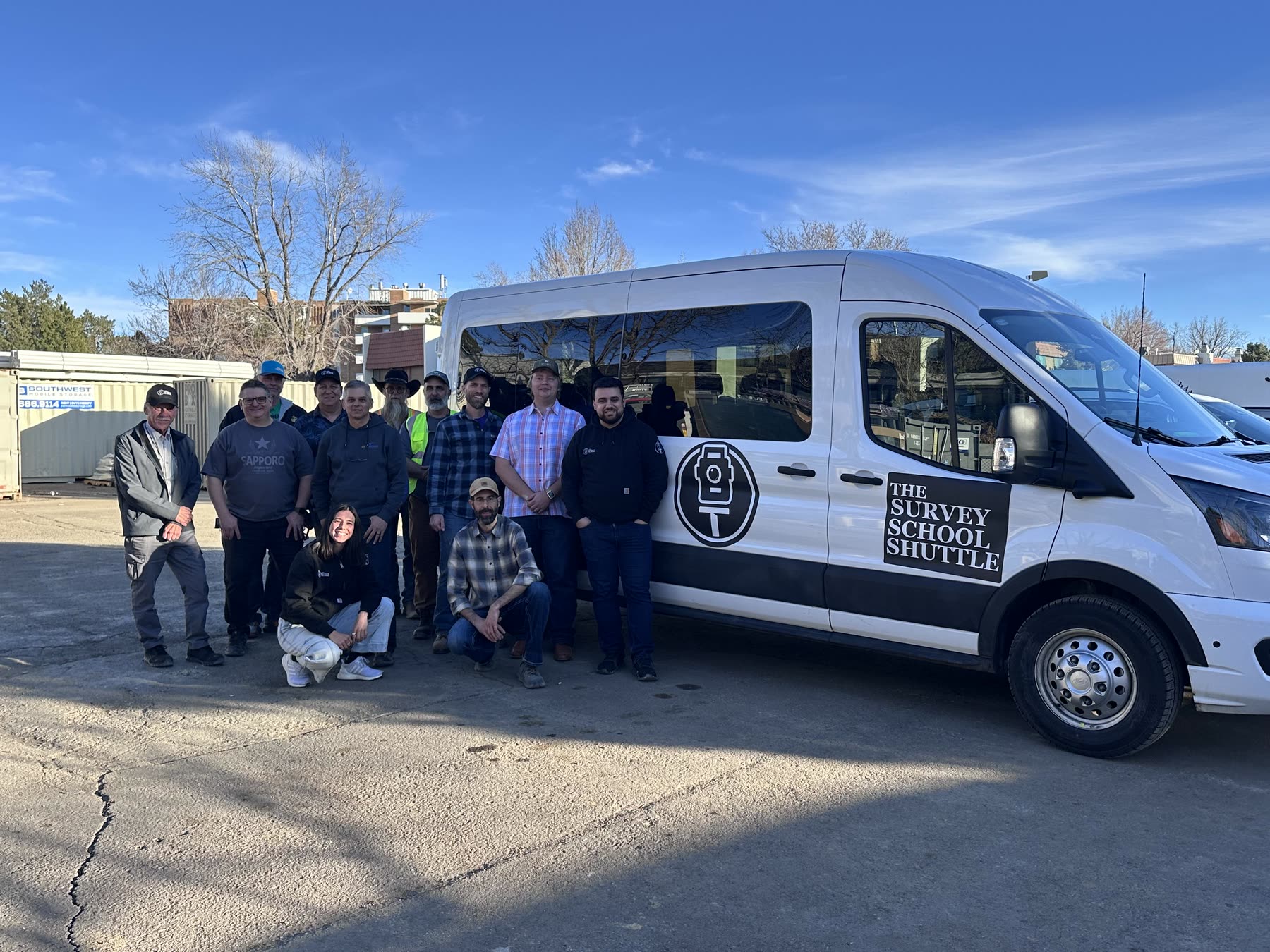Survey School members and instructors together beside the Survey School Shuttle